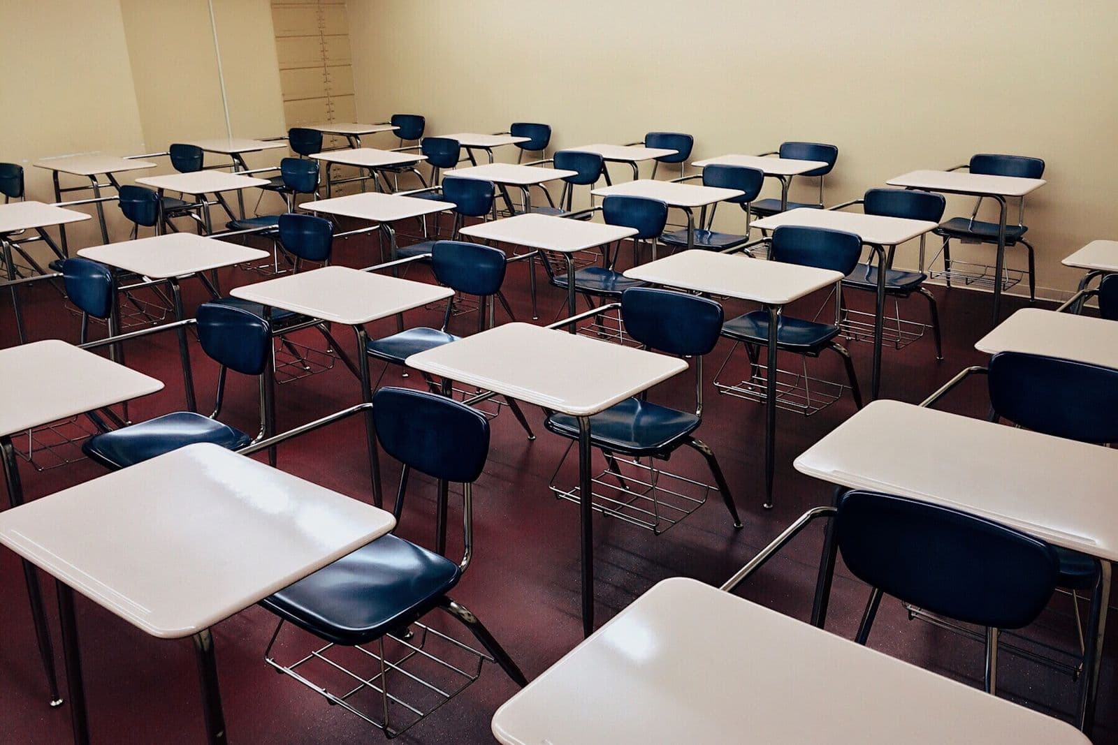 Empty classroom with desks on a resilient floor